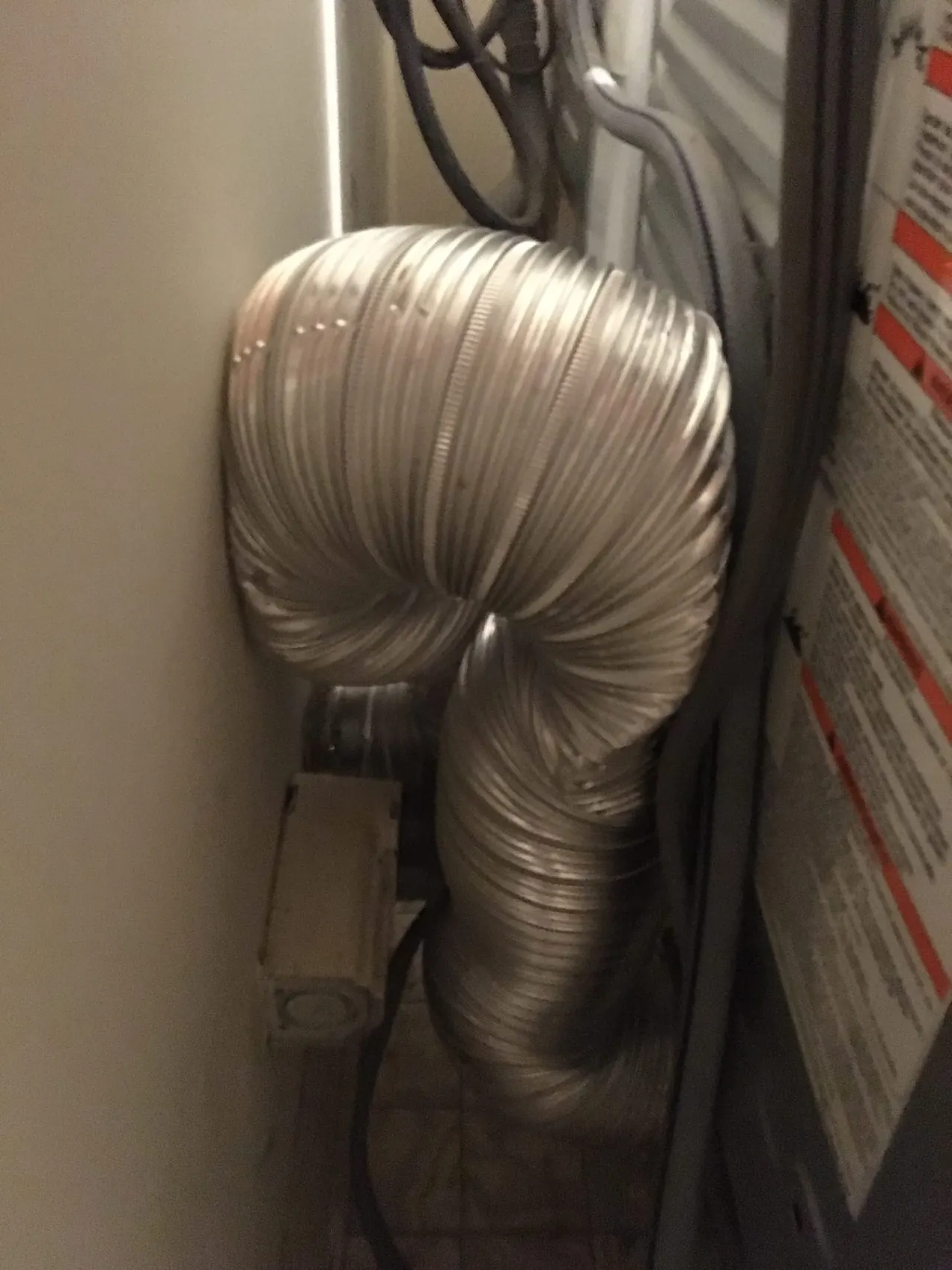 Flexible dryer duct behind a dryer